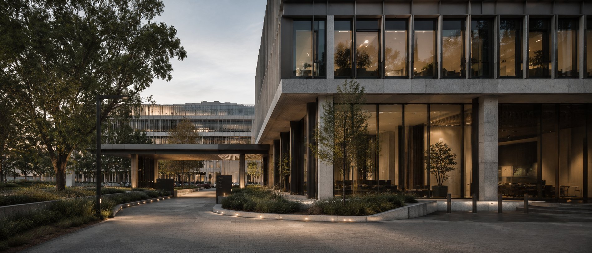 Mature Australian office building with warm interior activity, landscaped access and professionally managed operational performance.
