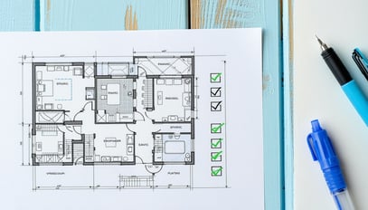 A blueprint and a checklist symbolizing the planni