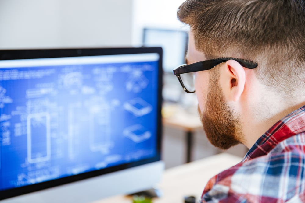 Image of man looking at construction plan